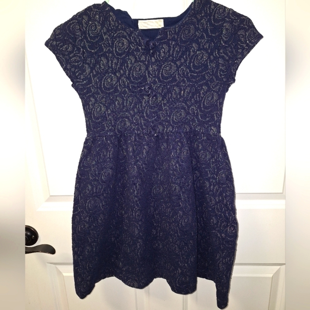 A Zara Girls black capped sleeve dress in a size 11/12. It's in great shape